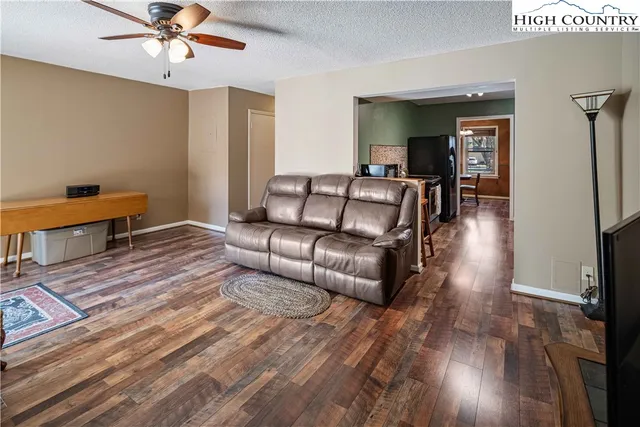 a living room with furniture and a wooden floor