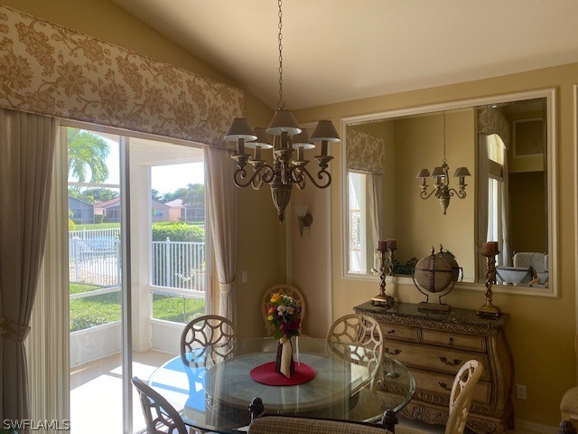 9319 Springview Loop Estero, FL 33928 - Photo 8 of 23 a dining room with furniture a chandelier and window