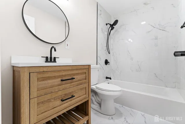 a bathroom with a sink a toilet and a mirror