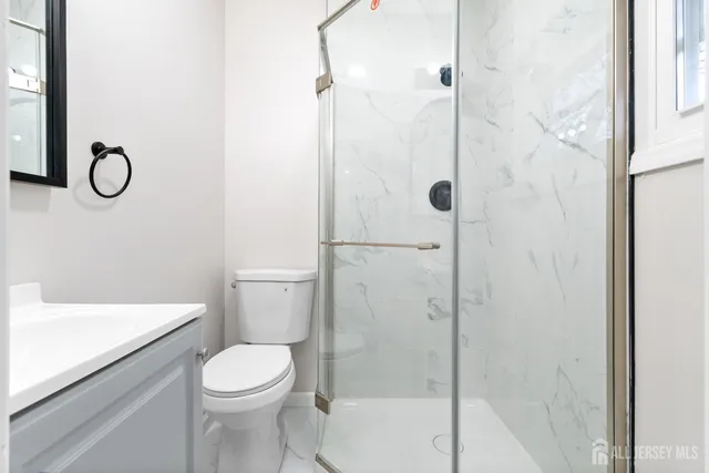 a bathroom with a toilet and a shower