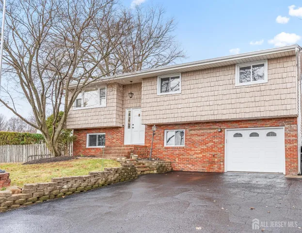 a view of a house with a yard and garage