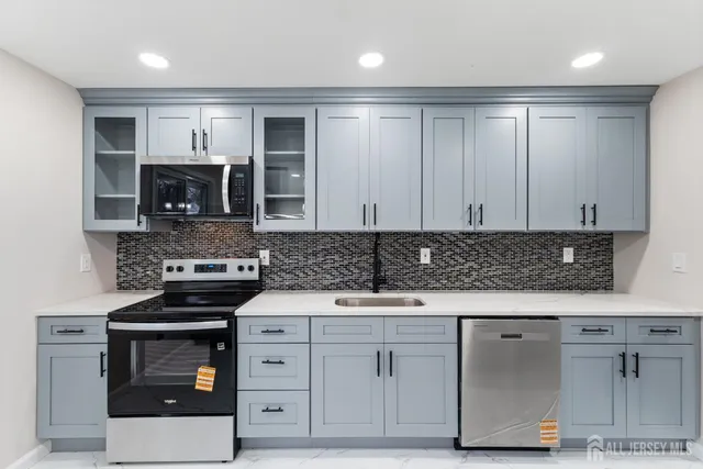 a kitchen with stainless steel appliances granite countertop a stove and a sink