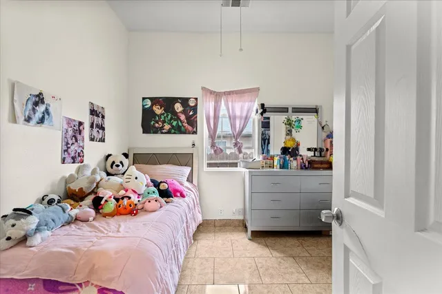 a bedroom with a bed dresser and a window