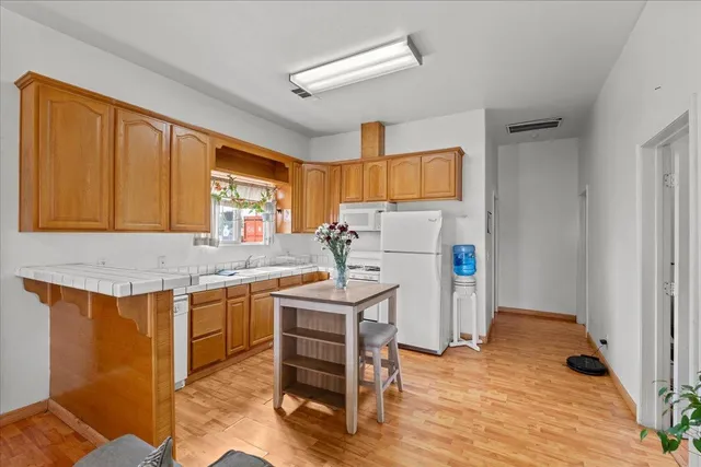 a kitchen with a sink a stove cabinets and counter space