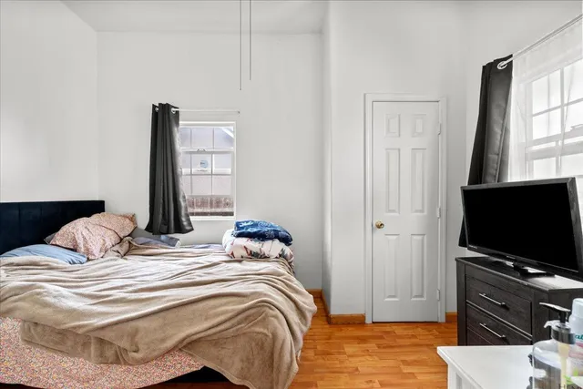 a bedroom with a bed and a flat screen tv