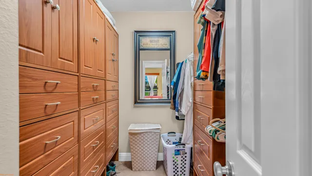 a view of walk in closet with clothes and shoes