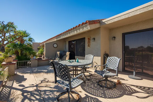 a view of a patio with couple of chairs