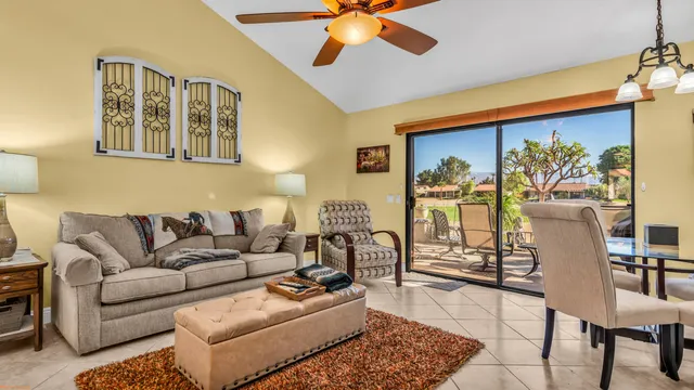 a living room with furniture and a painting on the wall