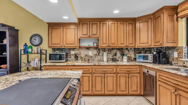 a kitchen with cabinets and a stove top oven