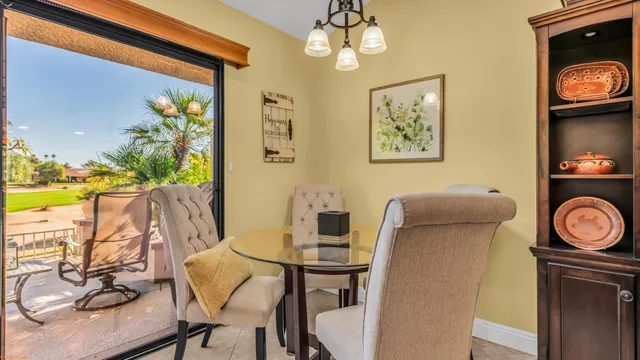 a view of a dining room with furniture and a flat screen tv