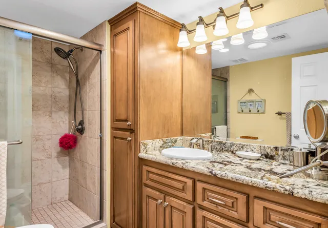 a bathroom with a granite countertop sink and a mirror
