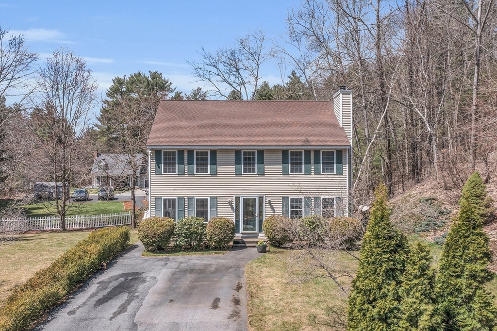 25 Hemlock Road Groton, MA 01450 - Photo 1 of 37 a front view of a house with a garden
