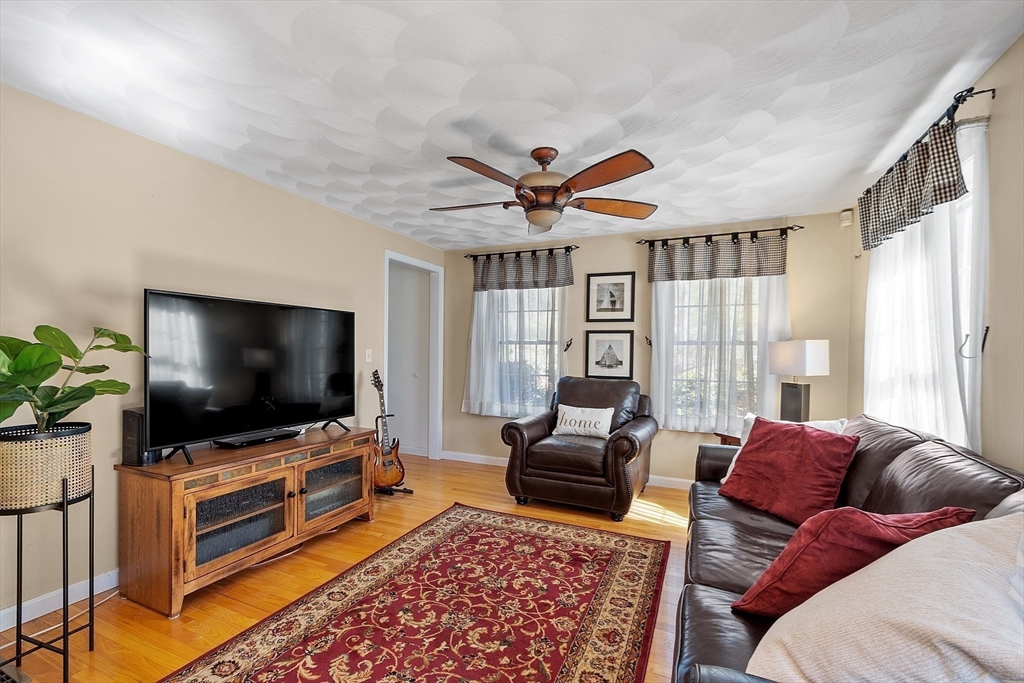 25 Hemlock Road Groton, MA 01450 - Photo 12 of 37 a living room with furniture and a flat screen tv