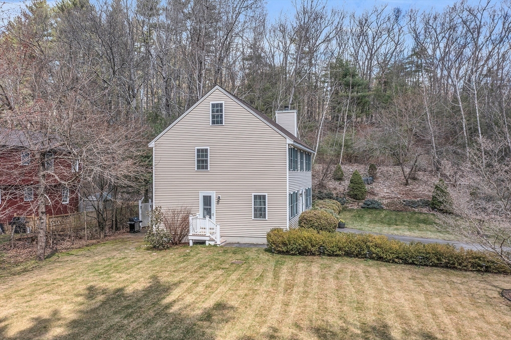 25 Hemlock Road Groton, MA 01450 - Photo 2 of 37 a view of a house with a yard and garage