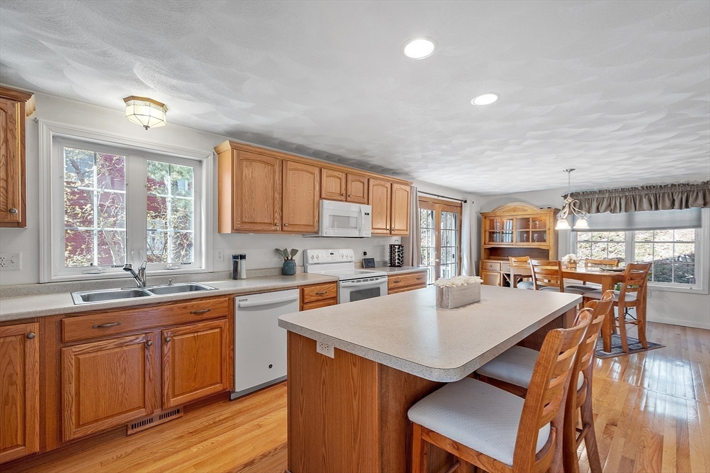 25 Hemlock Road Groton, MA 01450 - Photo 5 of 37 a kitchen with a stove a refrigerator and wooden cabinets
