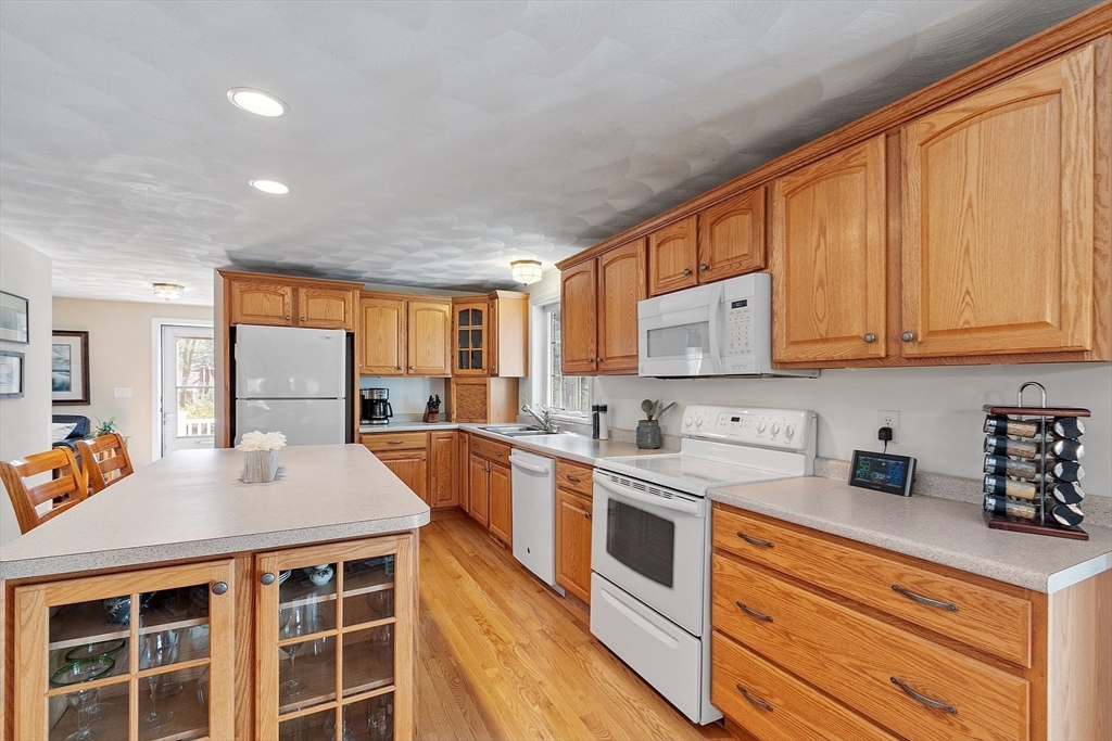 25 Hemlock Road Groton, MA 01450 - Photo 6 of 37 a kitchen with stainless steel appliances granite countertop a sink stove and cabinets