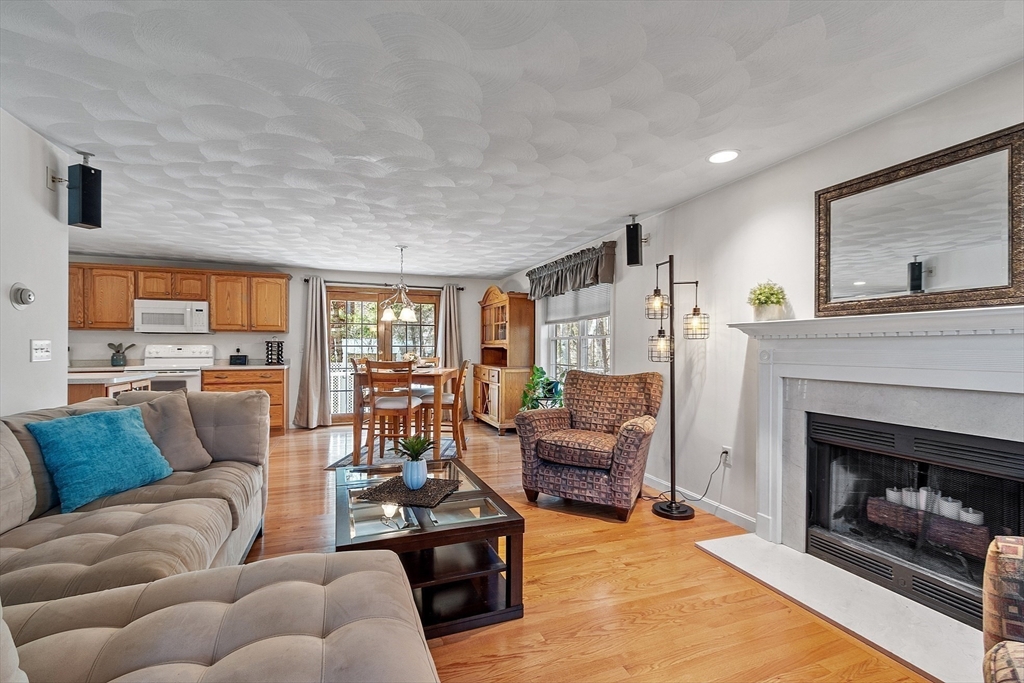 25 Hemlock Road Groton, MA 01450 - Photo 9 of 37 a living room with furniture and a fireplace