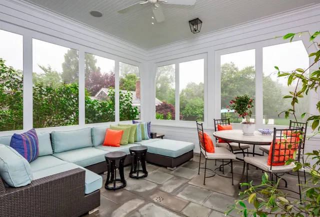 a balcony with furniture and a potted plant