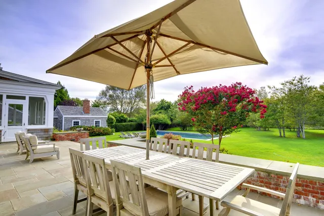a view of a backyard with sitting area