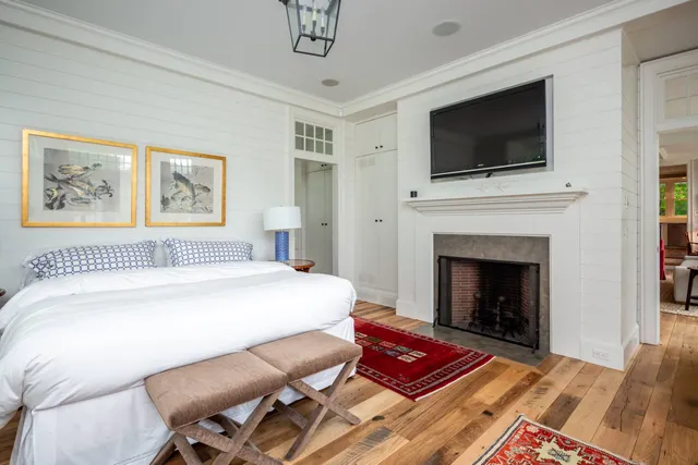 a spacious bedroom with a bed and a flat screen tv