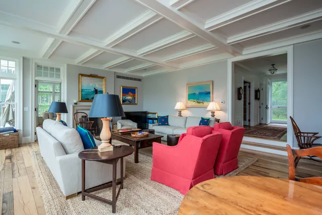 a living room with furniture or couch and a dining table with wooden floor