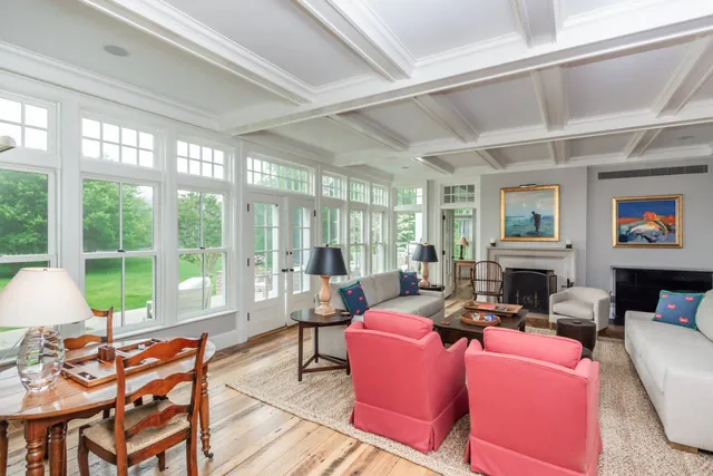 a living room with fireplace furniture and a large window