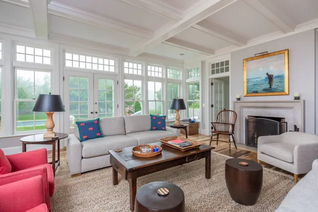 a living room with furniture a large window and a fireplace