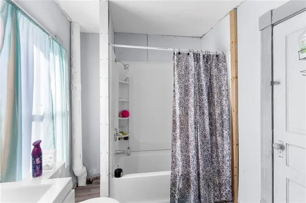 a bathroom with a shower and a bathtub