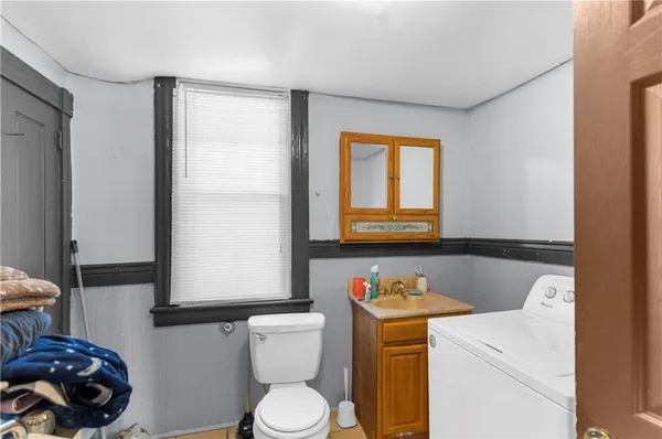 a bathroom with a sink toilet and mirror
