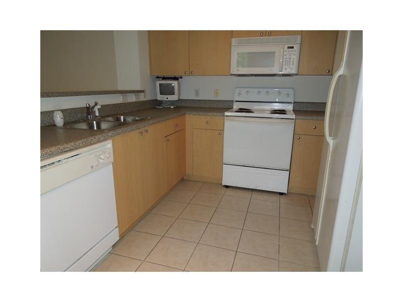 7940 North Nob Hill Road, Unit 204 Tamarac, FL 33321 - Photo 3 of 10 a kitchen with a sink cabinets and appliances