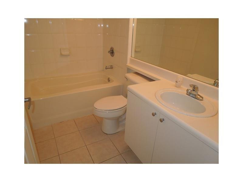 7940 North Nob Hill Road, Unit 204 Tamarac, FL 33321 - Photo 4 of 10 a bathroom with a sink toilet and shower