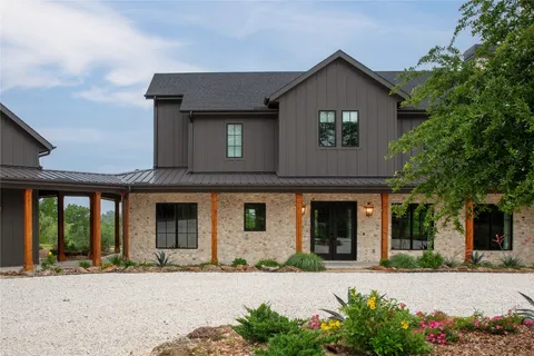 front view of a brick house with a small yard