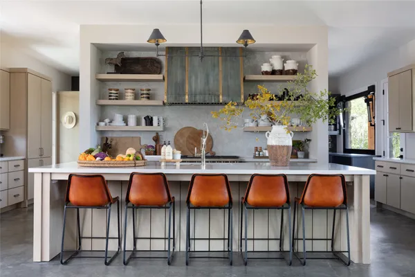 a kitchen with stainless steel appliances a sink and cabinets