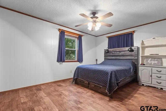 a spacious bedroom with a bed and a chandelier