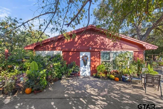 a view of a chair and tables in the patio