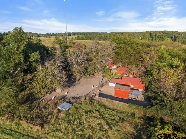 an aerial view of a house with a yard