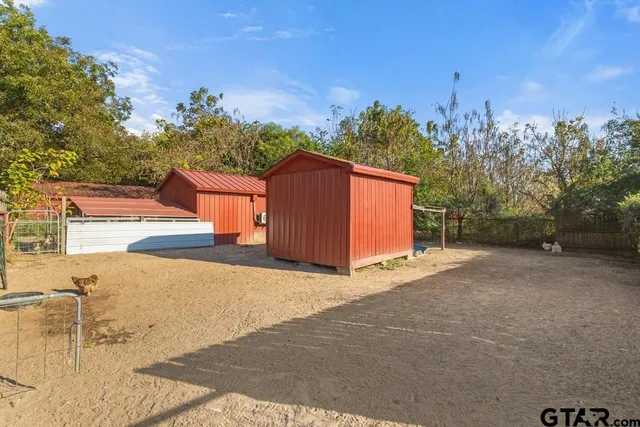 a backyard of a house with table and chairs