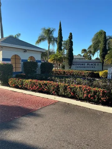 a front view of a house with a garden and yard