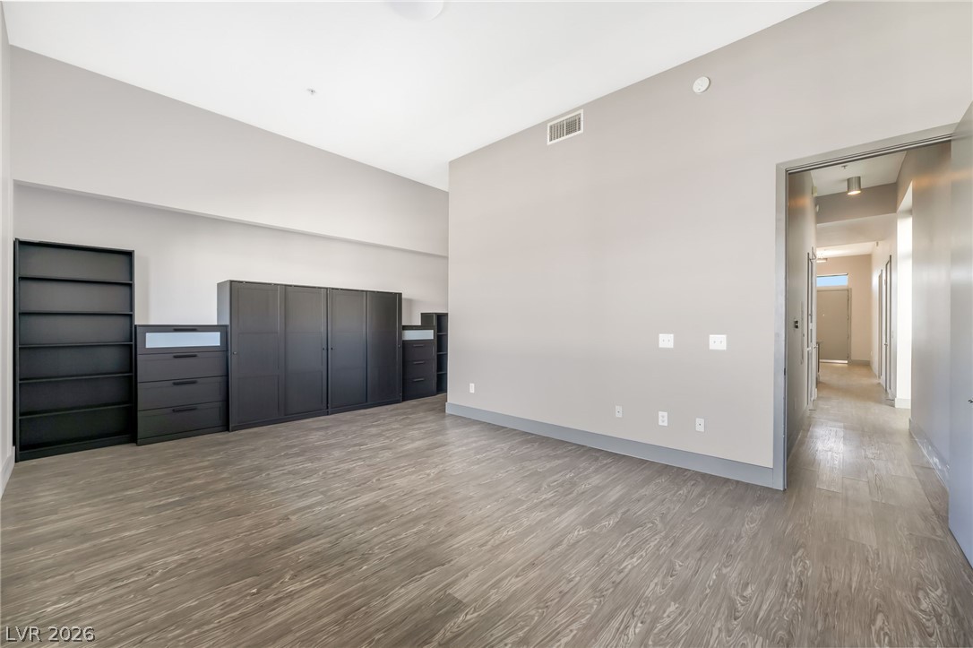 2775 West Pebble Road, Unit 505 Las Vegas, NV 89123 - Photo 13 of 26 Discover adaptable living with high ceilings and rich wood-style flooring, perfect for your unique vision.