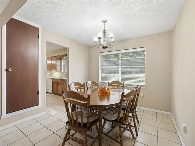 a view of a dining room with furniture and window