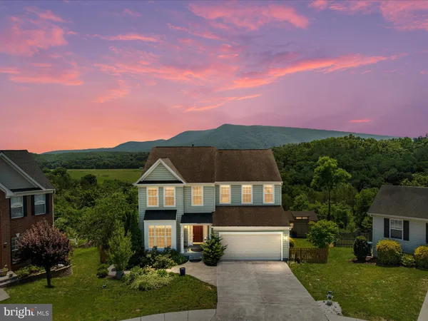 a front view of a house with a yard and a garage