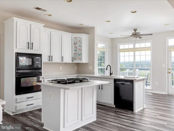 a kitchen with stainless steel appliances granite countertop a stove and a sink
