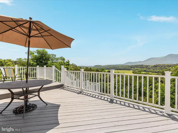a view of balcony with wooden floor and outdoor seating