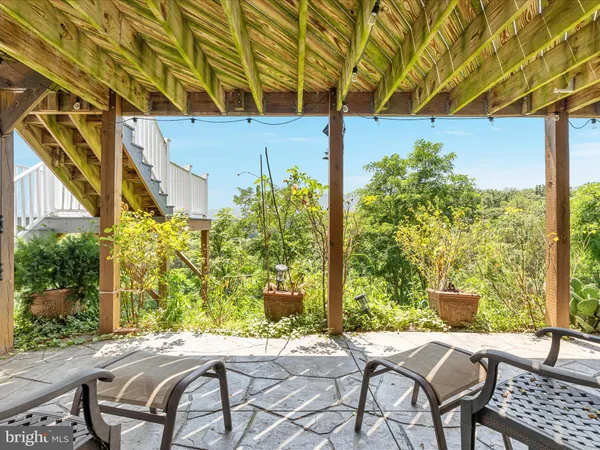 a view of backyard with a table and chairs and a fire pit