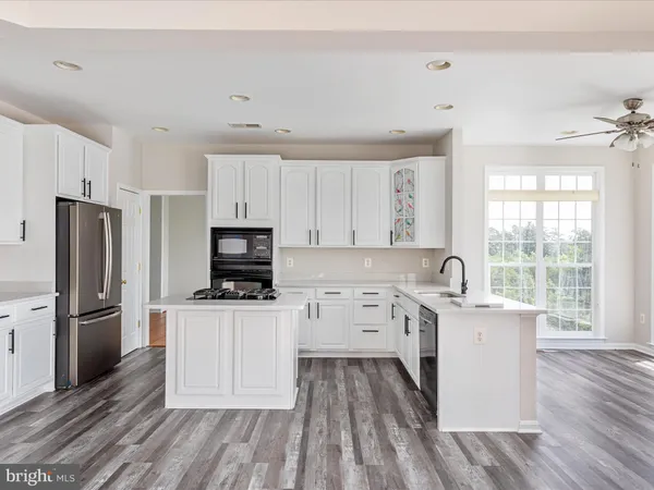 a kitchen with a sink stove and refrigerator