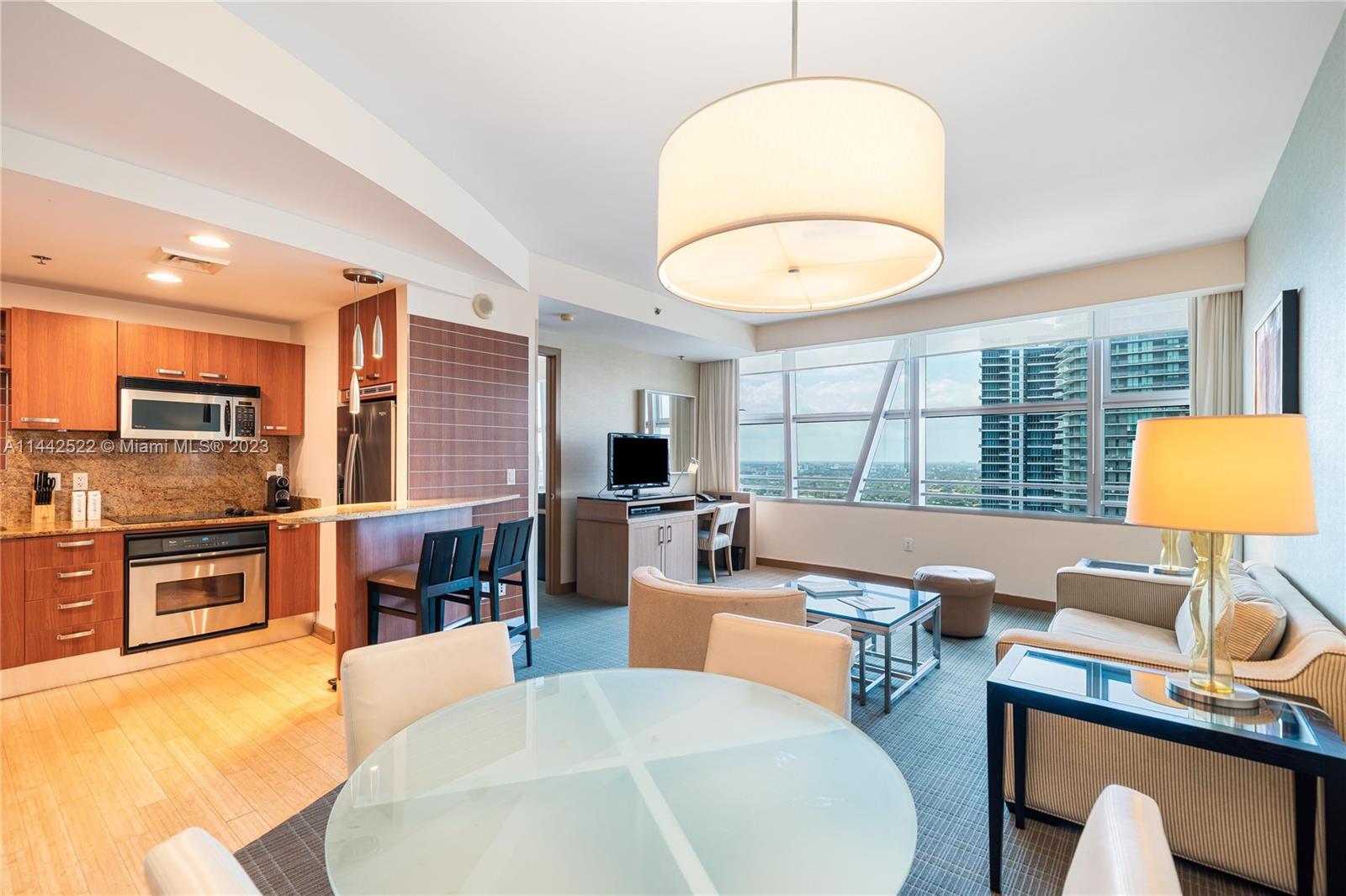 a living room with fireplace furniture and a large window