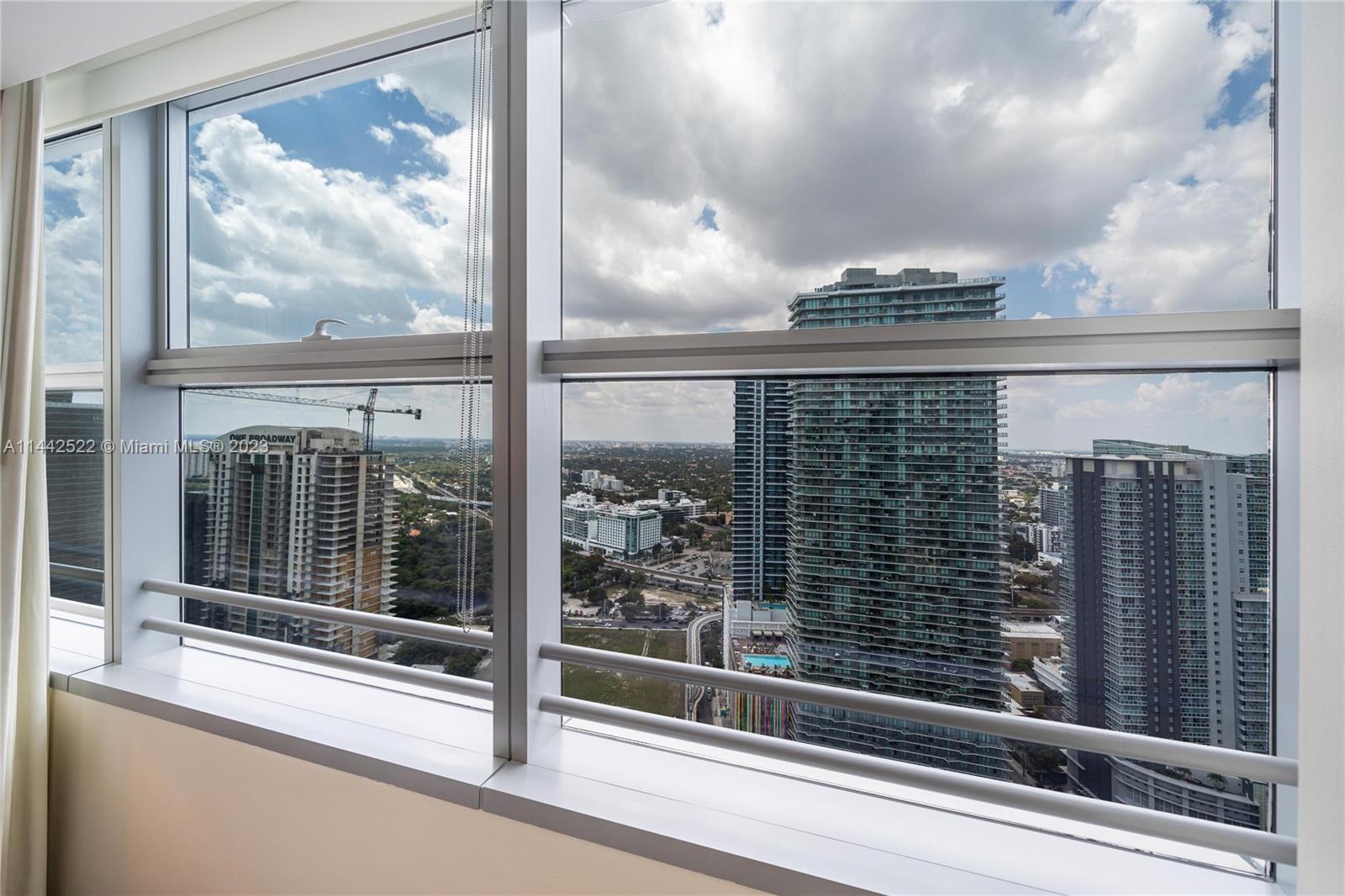 1395 Brickell Avenue, Unit 3205 Miami, FL 33131 - Photo 13 of 18 a view of a glass door with a door and a large window