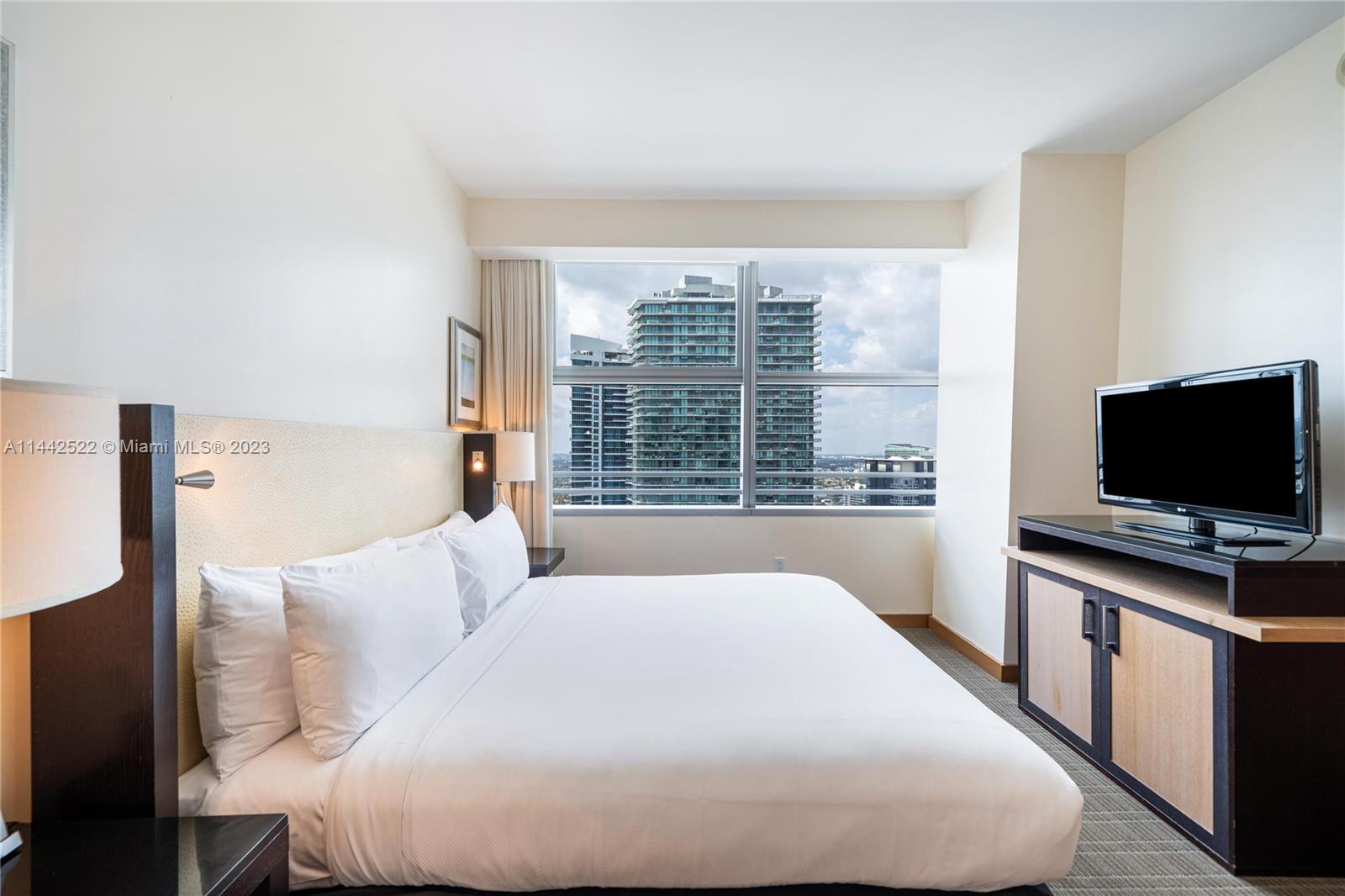 1395 Brickell Avenue, Unit 3205 Miami, FL 33131 - Photo 17 of 18 a bedroom with a bed and a flat screen tv