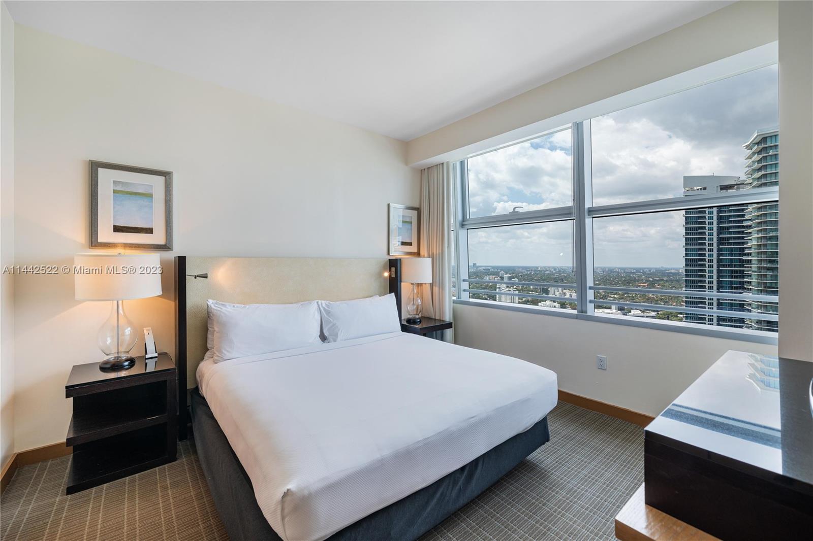 1395 Brickell Avenue, Unit 3205 Miami, FL 33131 - Photo 18 of 18 a bedroom with a large bed and a large window