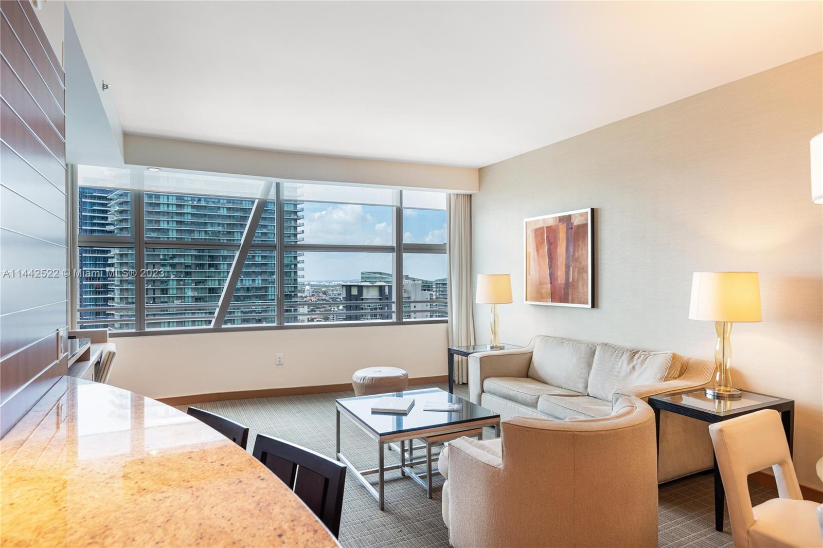 1395 Brickell Avenue, Unit 3205 Miami, FL 33131 - Photo 3 of 18 a living room with furniture and a large window